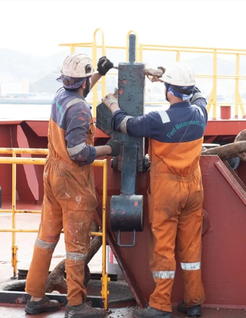 Seafarers fixing on vessel